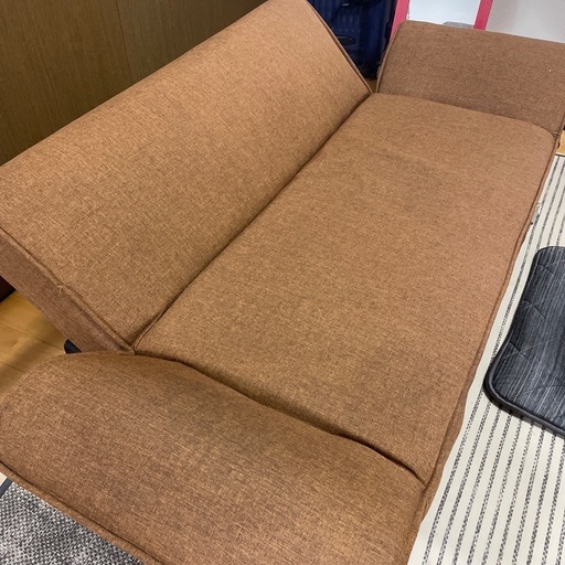 ブラウン色のフラットになるソファ